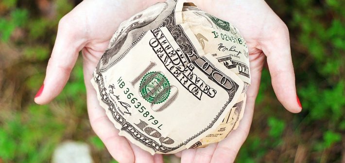 Woman holding emergency funds in the palm of her hand