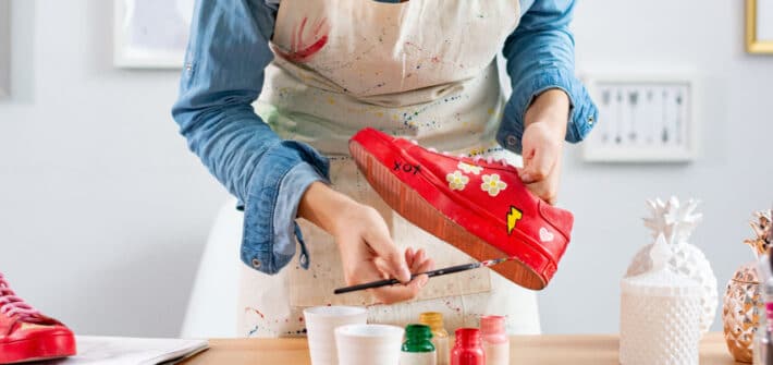 Woman painting a shoe.