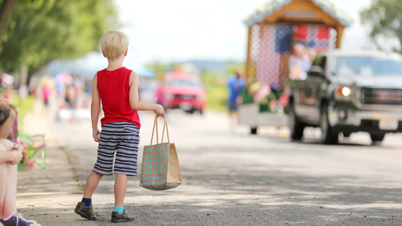 Children watching parade cars