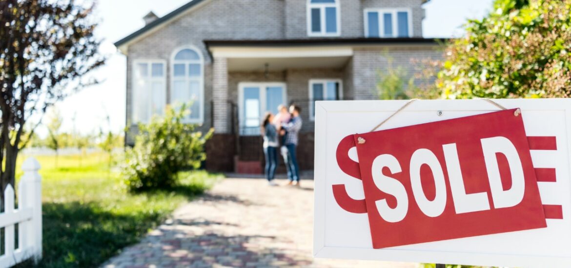 Nice house with sold sign out front