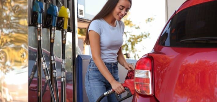 Woman putting fuel in car