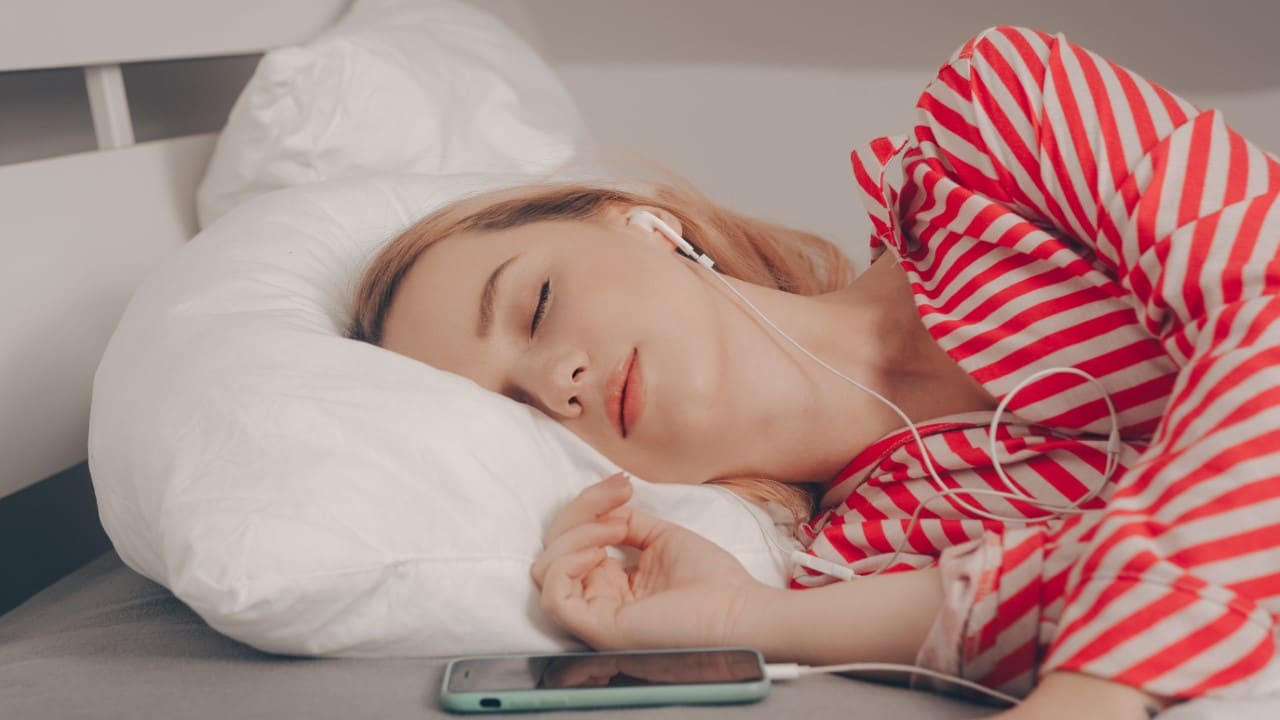 woman sleeping with earphones in