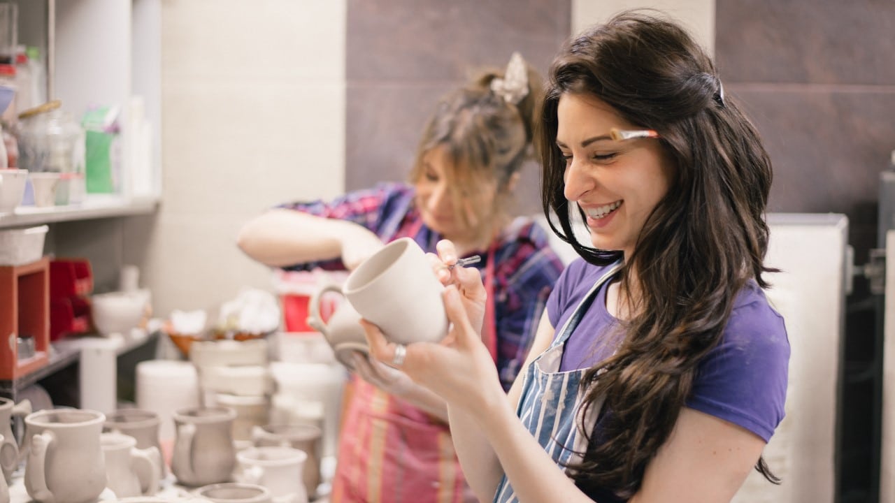 women enjoying pottery