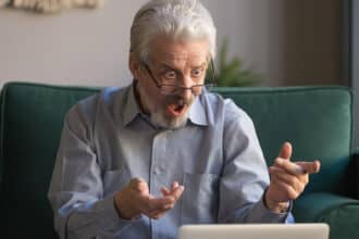 Shocked stressed senior mature man looking at laptop reading unbelievable online news at home, crazy senior old grandpa feel bad surprise with unexpected computer problem, frustrated by system virus