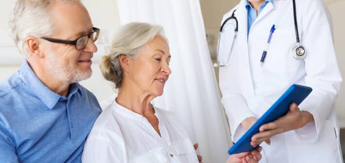 medicine, age, health care and people concept - senior woman, man and doctor with tablet pc computer at hospital ward