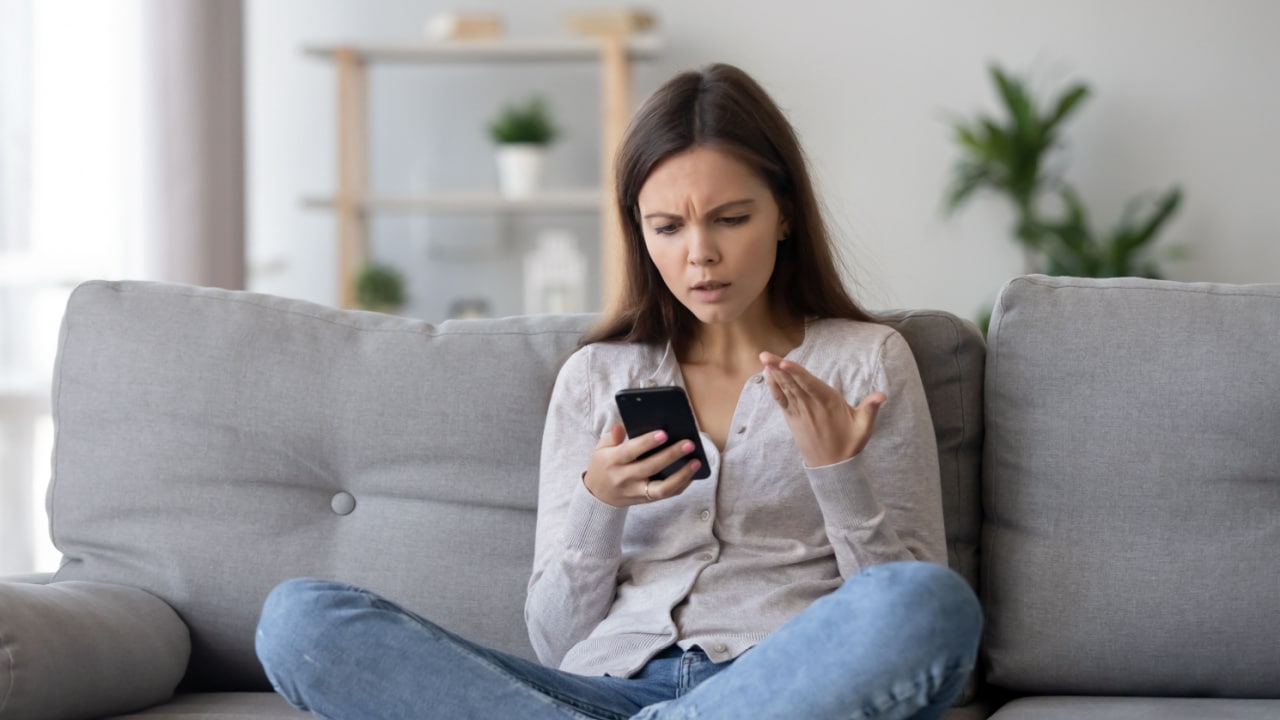 Upset woman reviewing terms and conditions of her trip