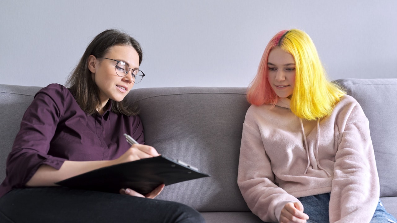 Mom sitting with daughter explaining some personal family issues