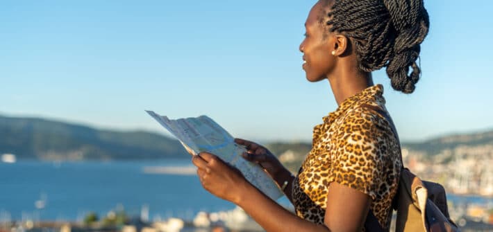 Young tourist woman viewing a map