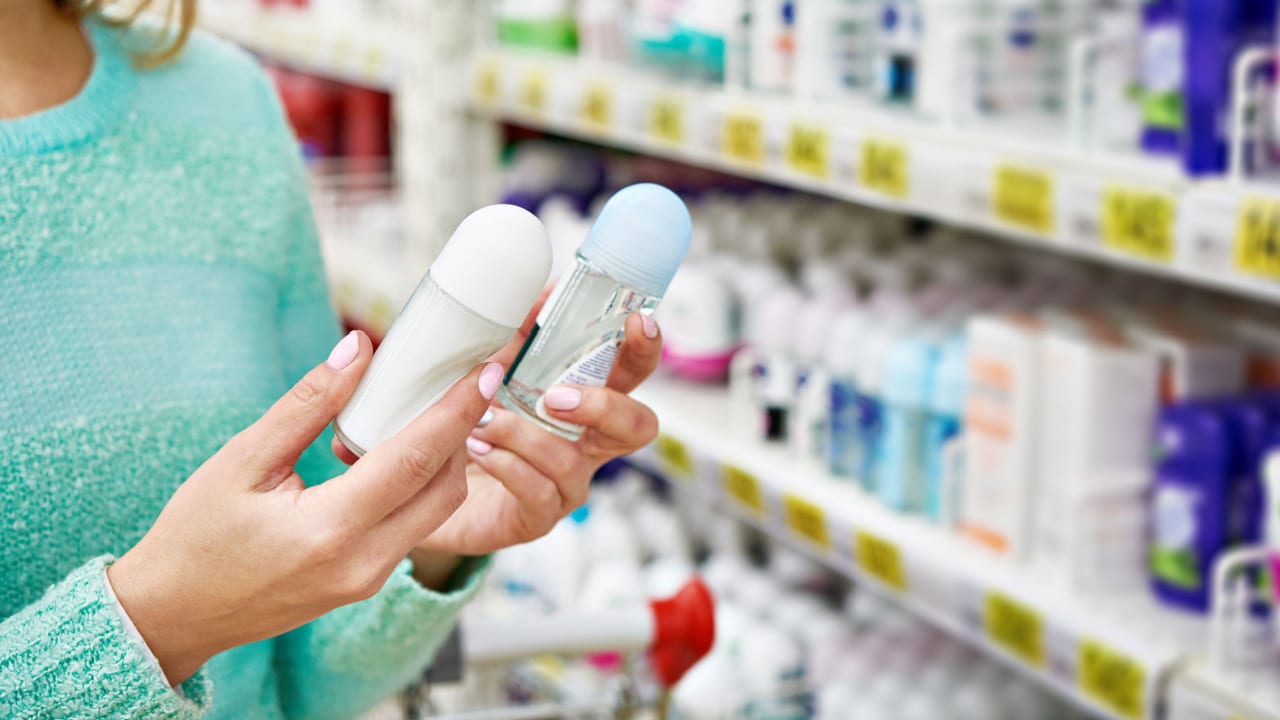 Woman in shop comparing deodorants