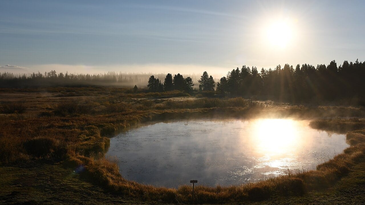 West Yellowstone landscape during late September as the sun rises above a pond.