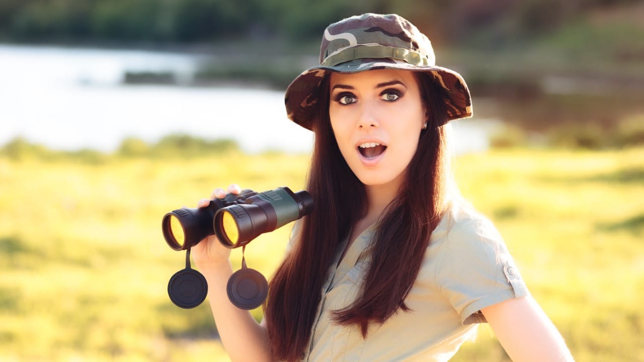 Woman Explorer With Camouflage hat and Binoculars